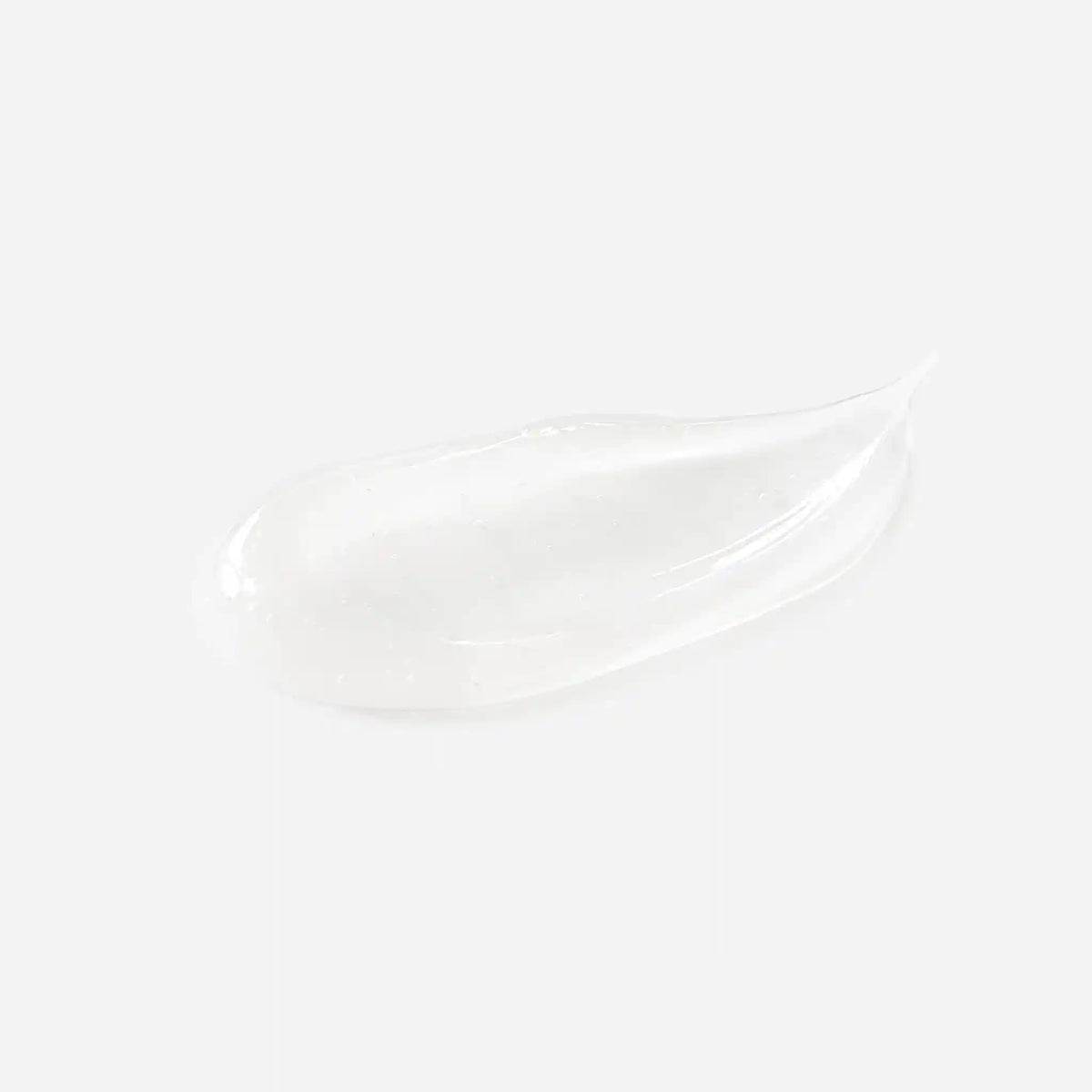 A close-up of a hand dispensing a small dollop of white cream from a shiny silver pump bottle onto another finger, against a clean light gray background.